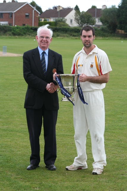 NCU President Dr Murray Power presents the Ulster Bank League Section One Trophy to Lurgan captain Steven Chambers